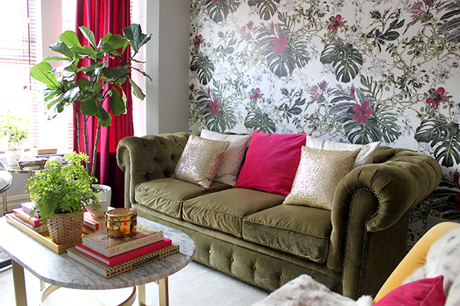 Swoon Worthy living room with Sian Zeng Summer Tropical Blossom wallpaper in olive and berry pink