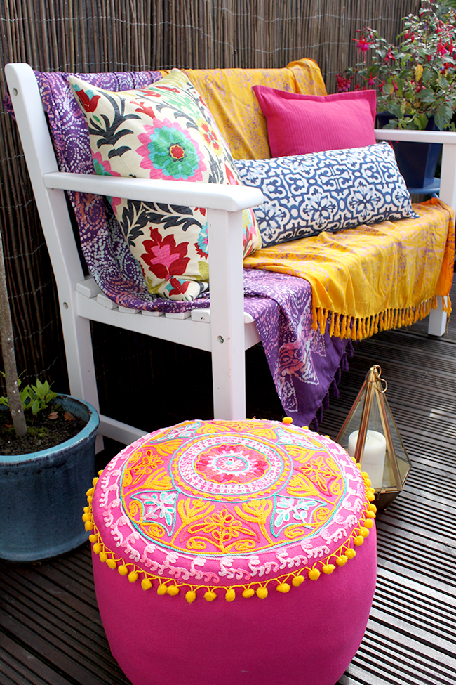 Eclectic Boho Glam Garden Reveal - Swoon Worthy - Boho textiles on white bench