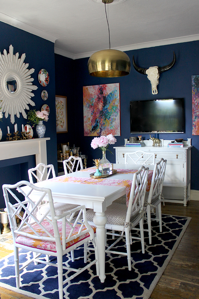 Swoon Worthy - dark blue dining room with white furniture and bright accents