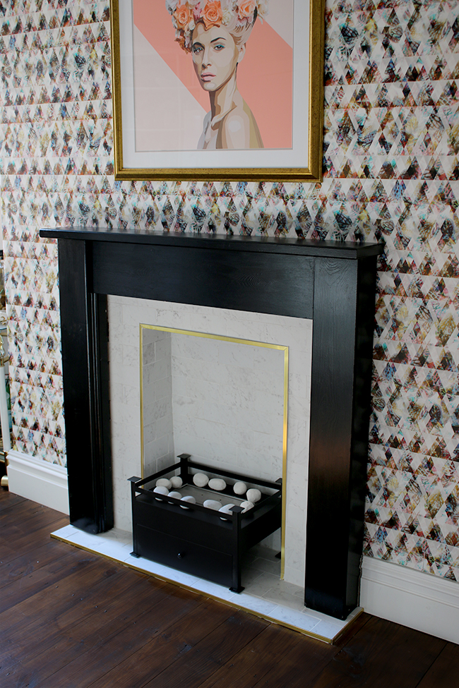 marble tile fireplace with brass trim and black hearth with graphic wallpaper - see the whole process on www.swoonworthy.co.uk