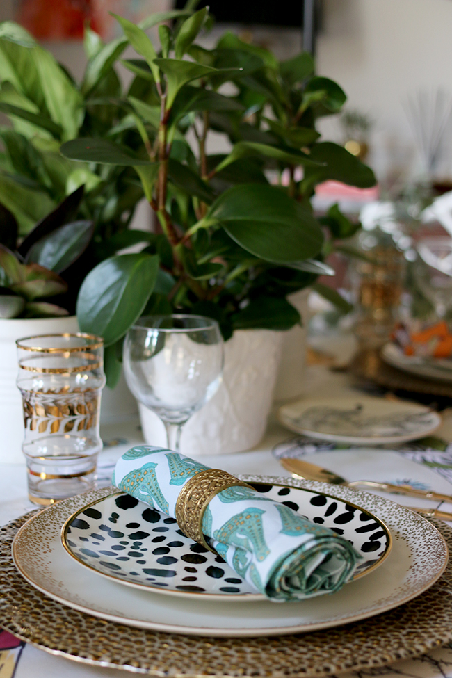 Colourful boho glam table setting with plants and animal prints
