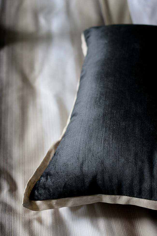 dark grey velvet cushion with taupe trim
