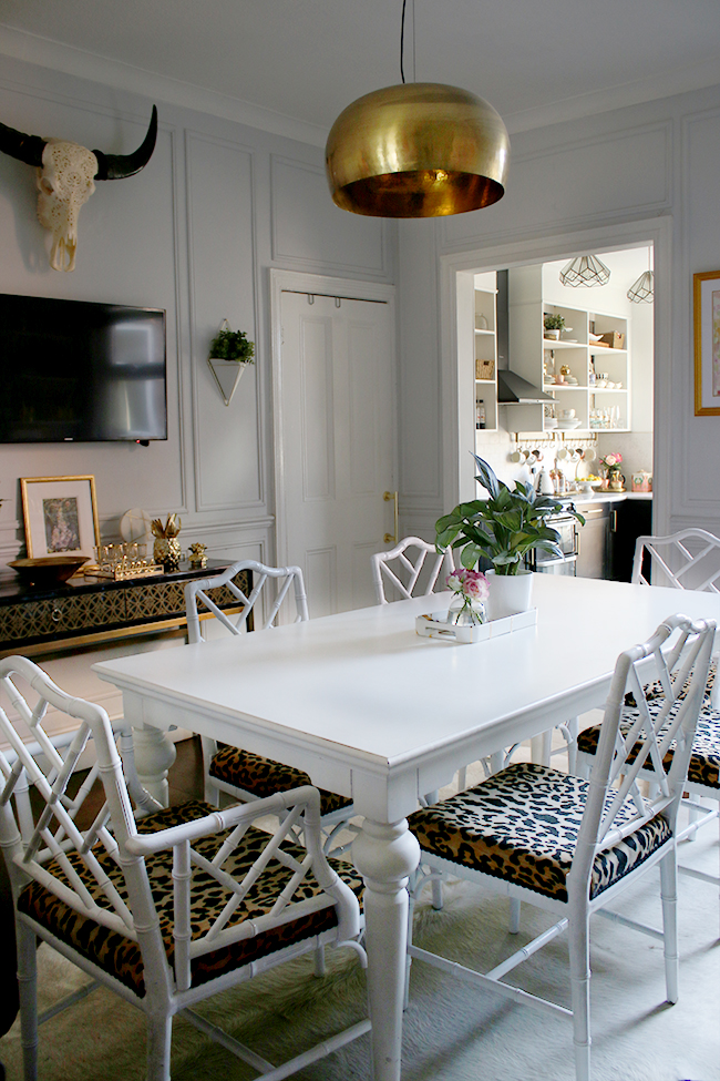 dining room with white cowhide and leopard print chairs
