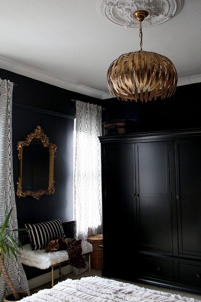 gold ceiling light in black bedroom with geometric curtains boho glam
