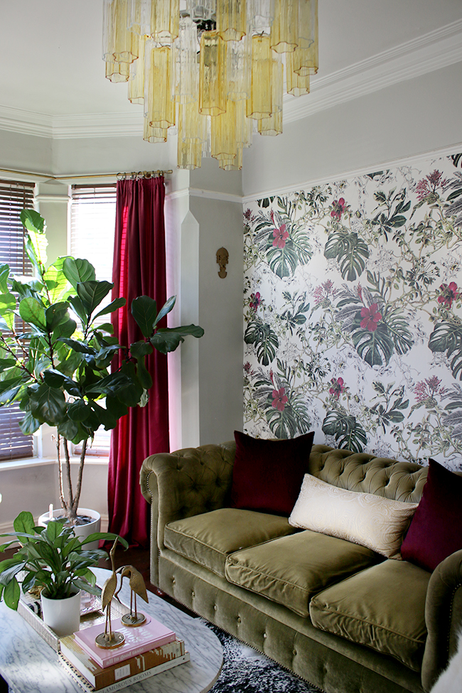 eclectic boho glam living room with tropical wallpaper and murano glass chandelier
