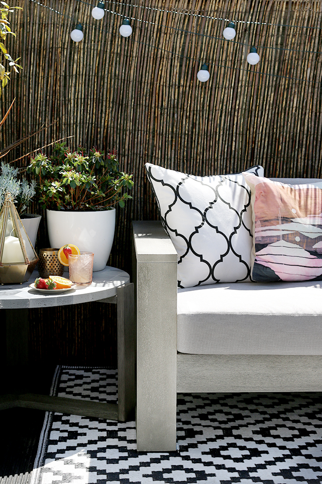 garden patio design with grey sofa and gold accents