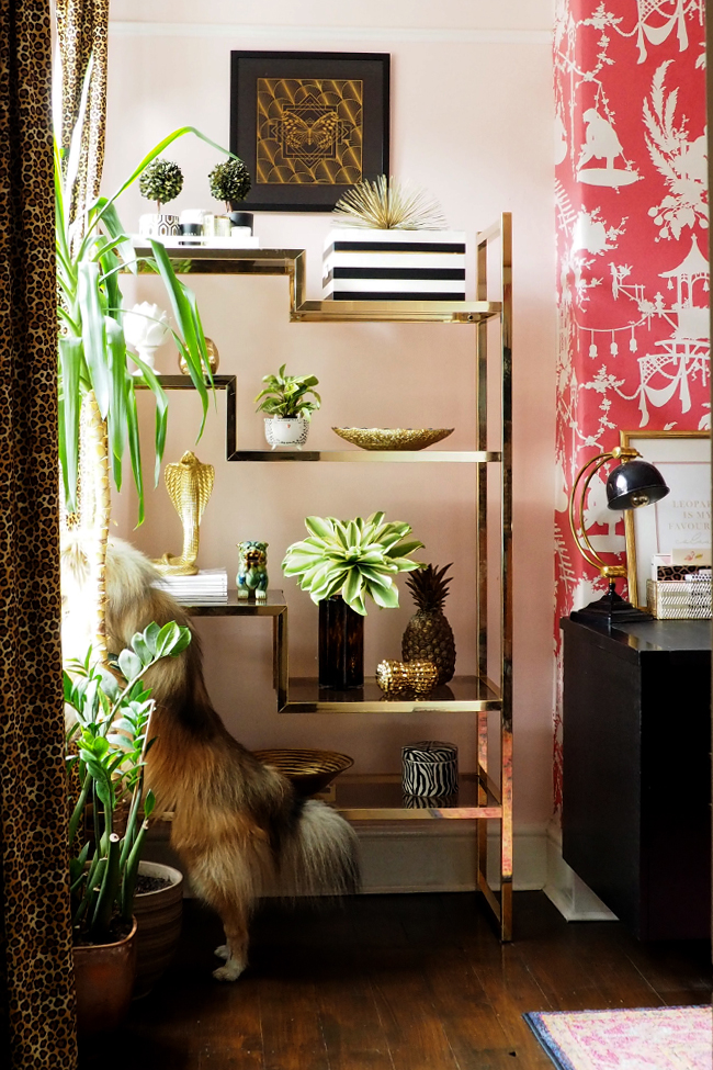 Brass and glass vintage shelving unit in pink office