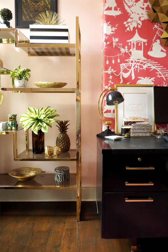 boho glam office with black desk and gold brass glass shelving units