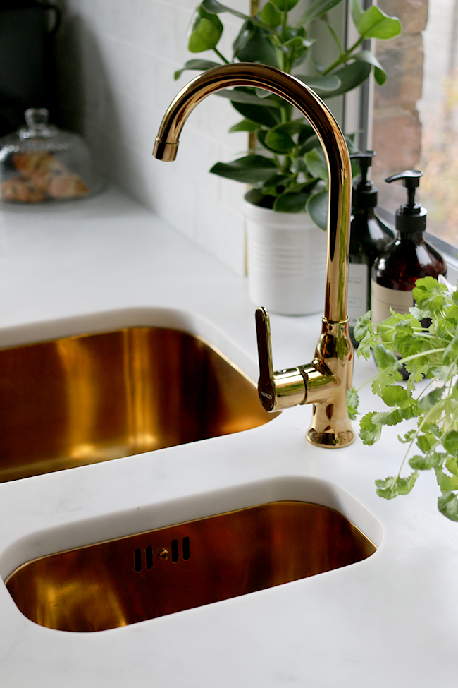 gold kitchen sink and tap