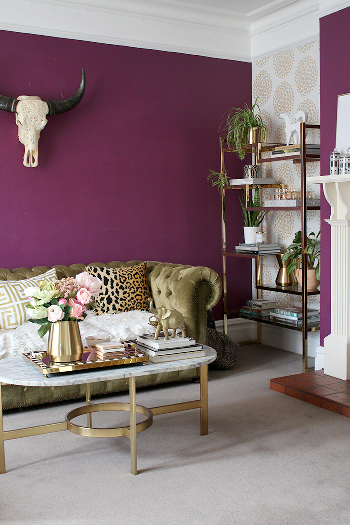 plum purple living room with green chesterfield sofa