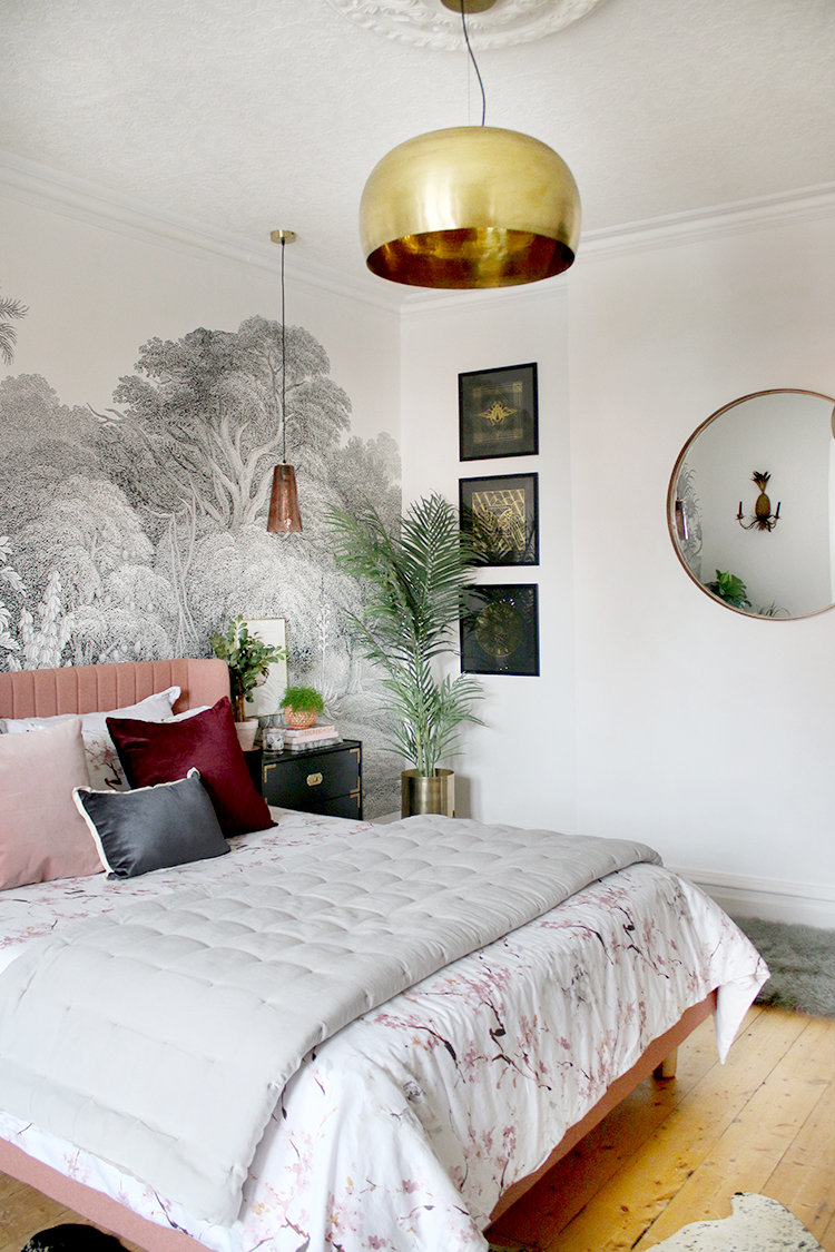 boho jungle glam bedroom with pink bed and pendant lights