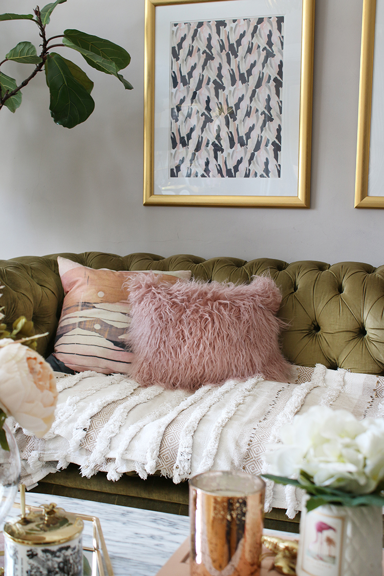 olive green velvet chesterfield sofa with pink and peach cushions