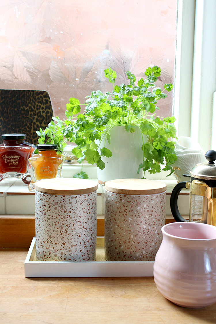 terrazzo style cannisters on wood worktop in kitchen
