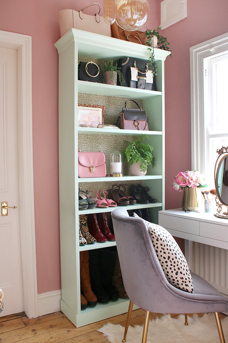 Vanity area with shelving styled with shoes and bags