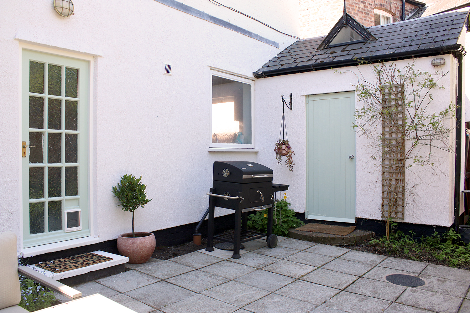 Courtyard garden with pale green and pink accents