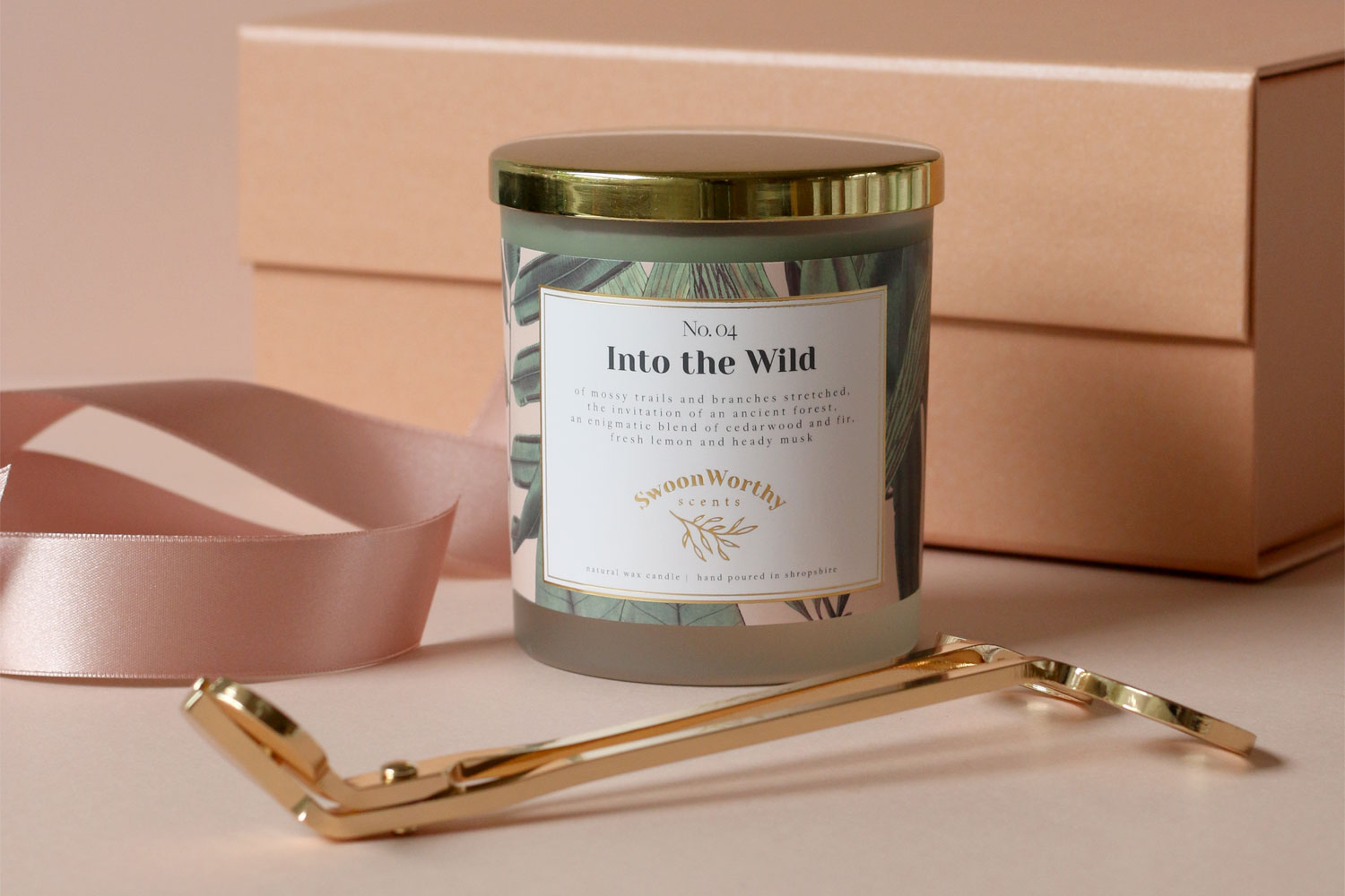 gold candle lid on Swoon Worthy Scents Into the Wild candle