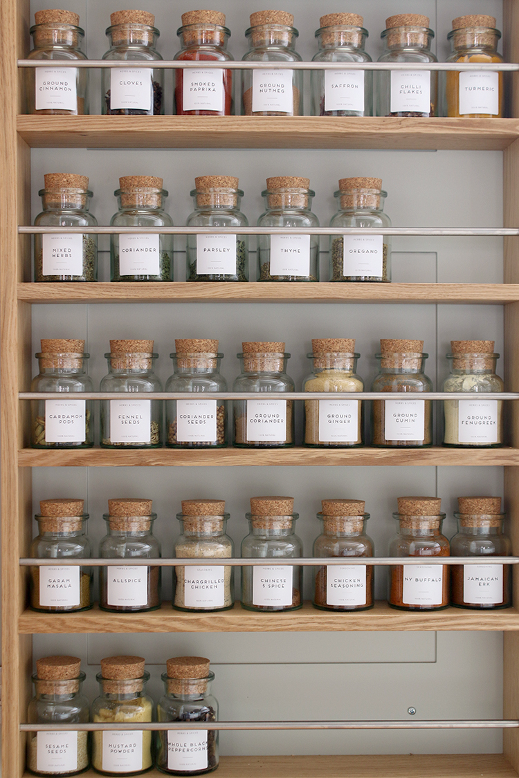 spice rack with labelled jars neatly displayed in a row